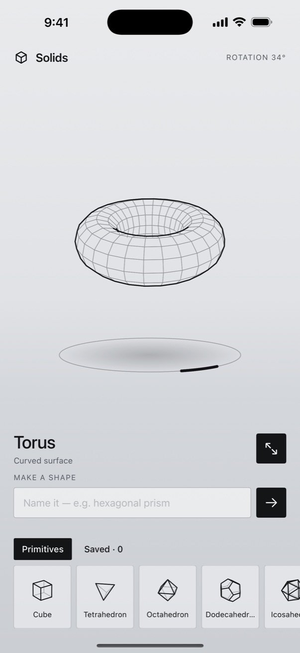 Solids3D library screen showing a torus in wireframe, spinning on a turntable, with a tray of shapes below